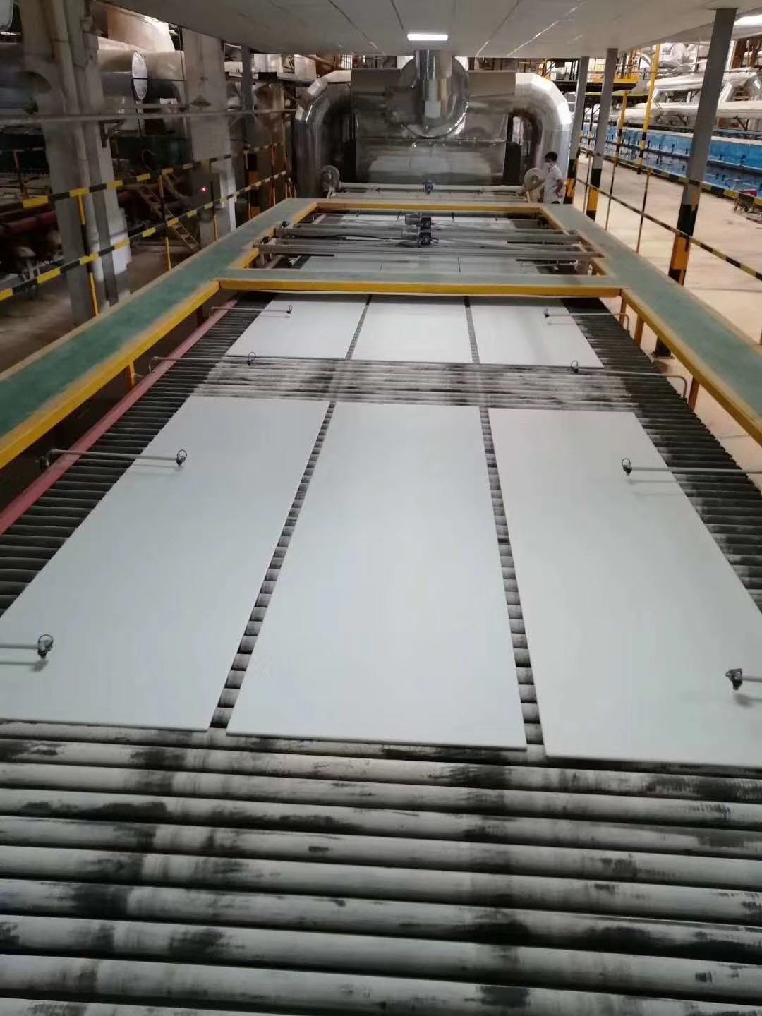 Porcelain tiles on conveyor belt during production, large-scale manufacturin