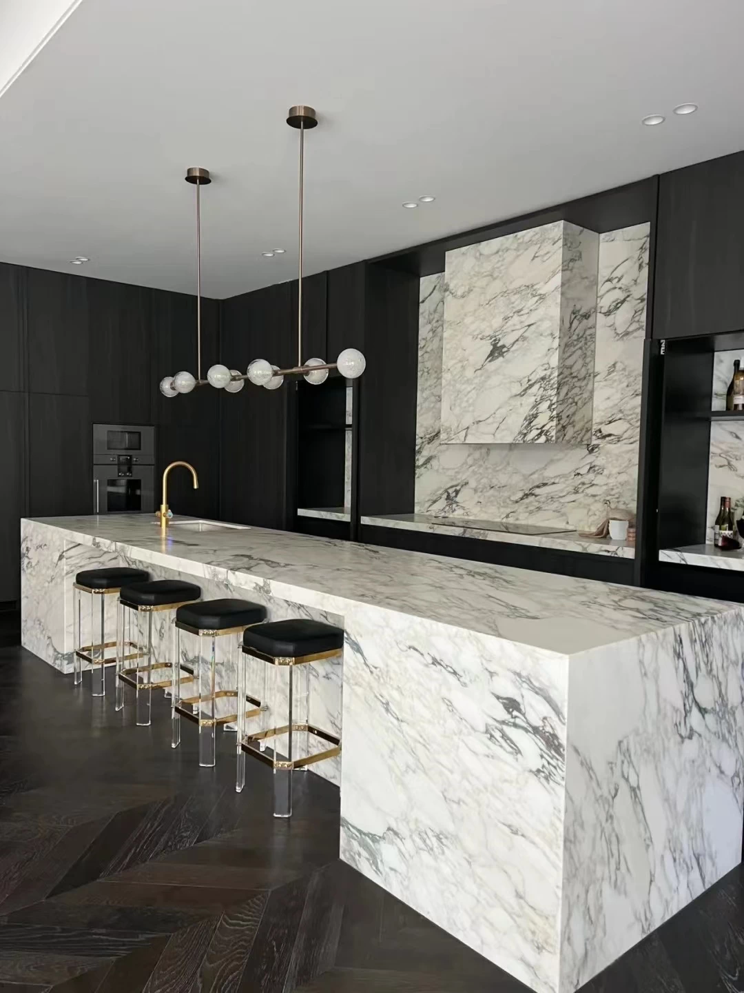 White marble-look sintered stone waterfall kitchen island in luxury home