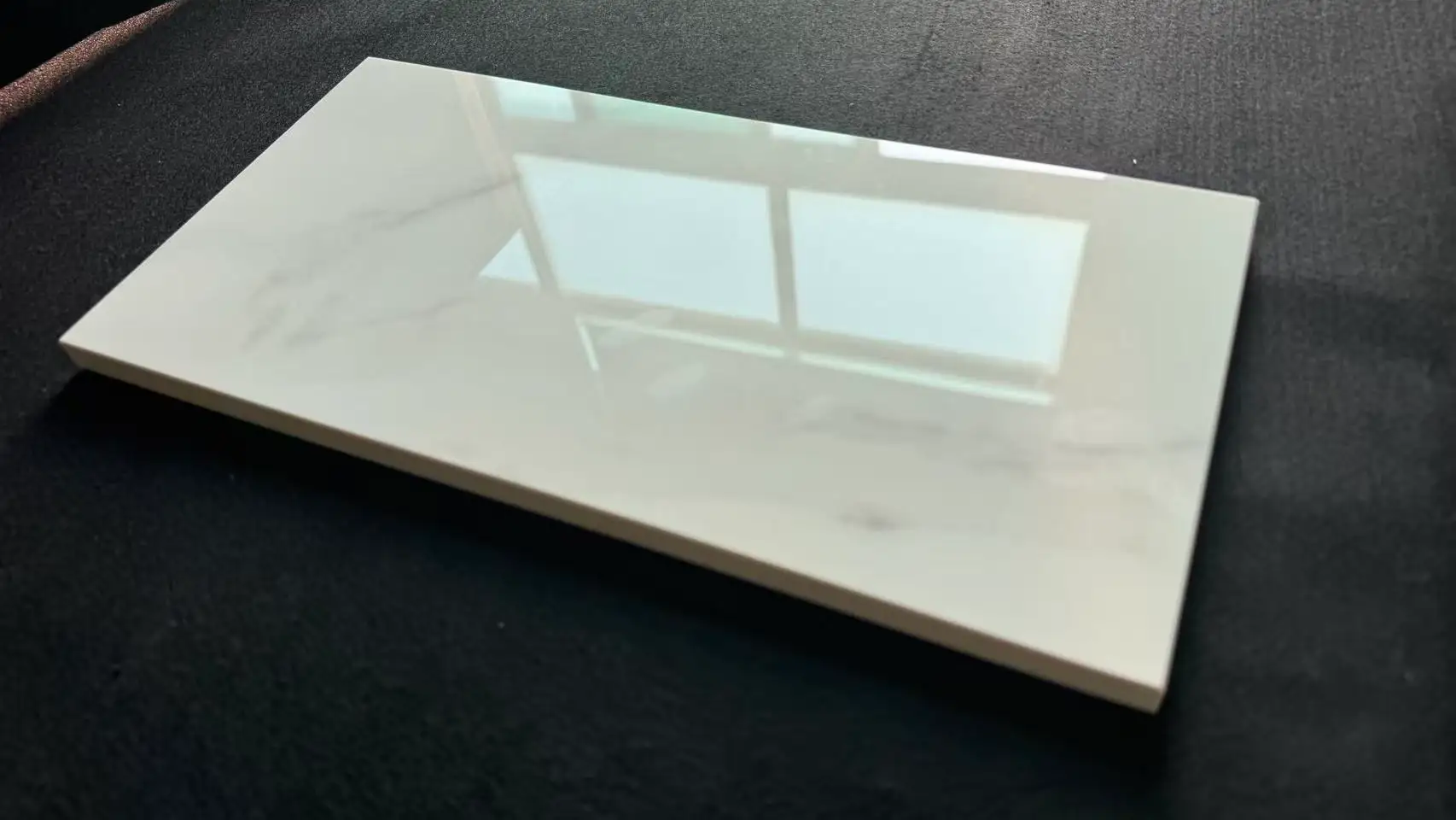 White polished porcelain tile sample with soft marble vein