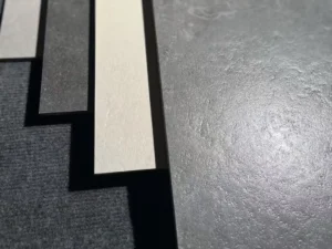 Close view of structured porcelain floor tile surface under natural light