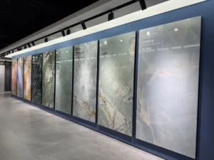 China tile showroom with large marble-look porcelain slabs displayed on a wall in multiple colors and patterns