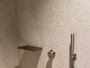 Textured china bathroom tile close-up for shower wall application with modern brushed stone-look porcelain finish