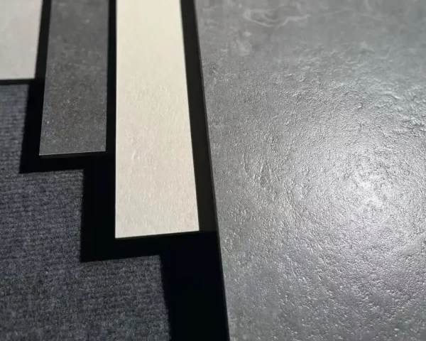 Close view of structured porcelain floor tile surface under natural light