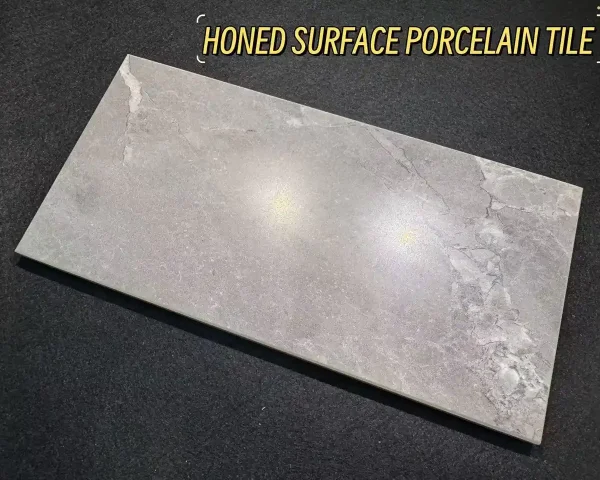 Grey honed surface porcelain tile slab with soft sheen and subtle stone veining for contemporary interiors