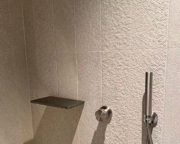 Textured china bathroom tile close-up for shower wall application with modern brushed stone-look porcelain finish