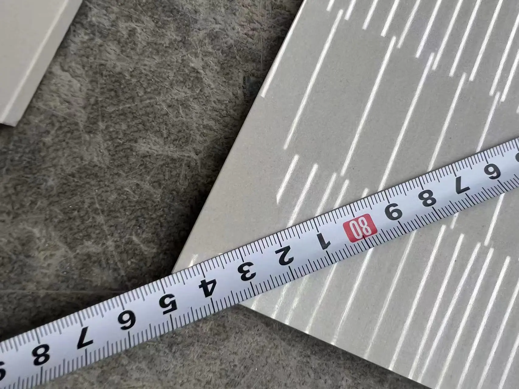 Porcelain tile measured with tape, ensuring accurate size and quality