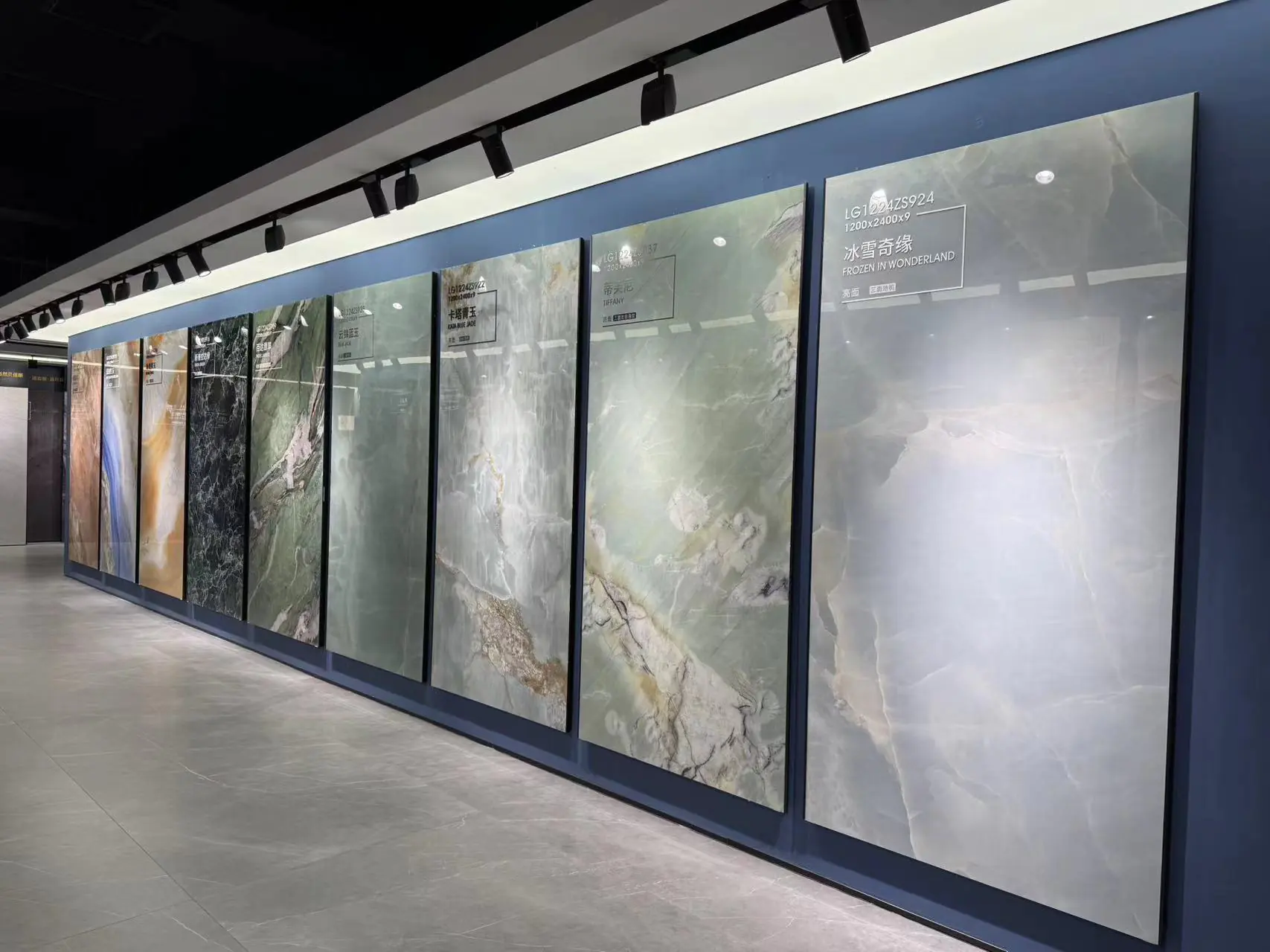 Colorful sintered stone slab designs displayed vertically in showroom