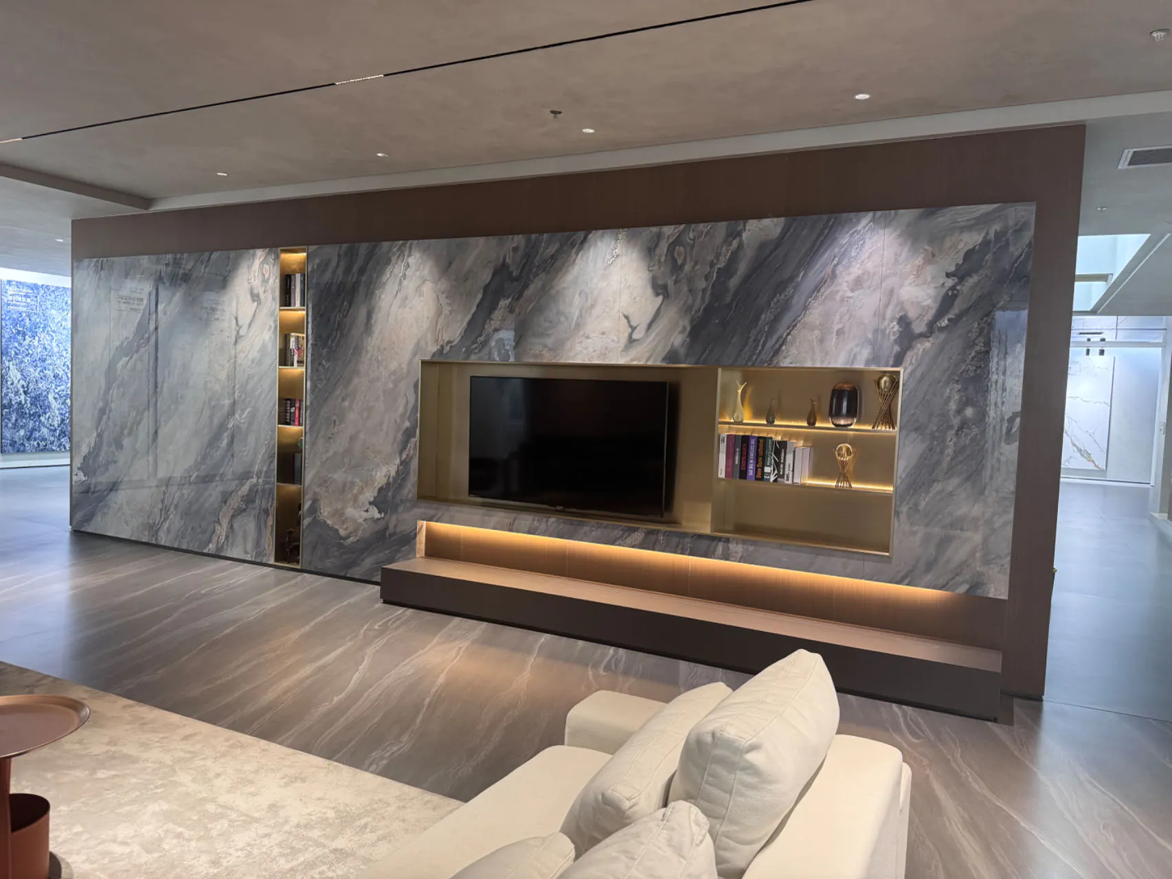 Sintered stone TV wall with elegant built-in shelves