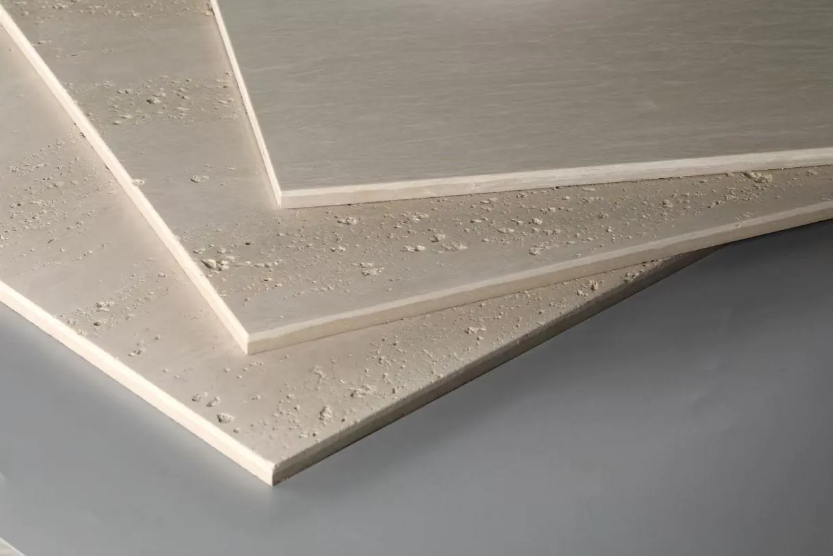 Porcelain tile mimicking pitted travertine stone surface close-up