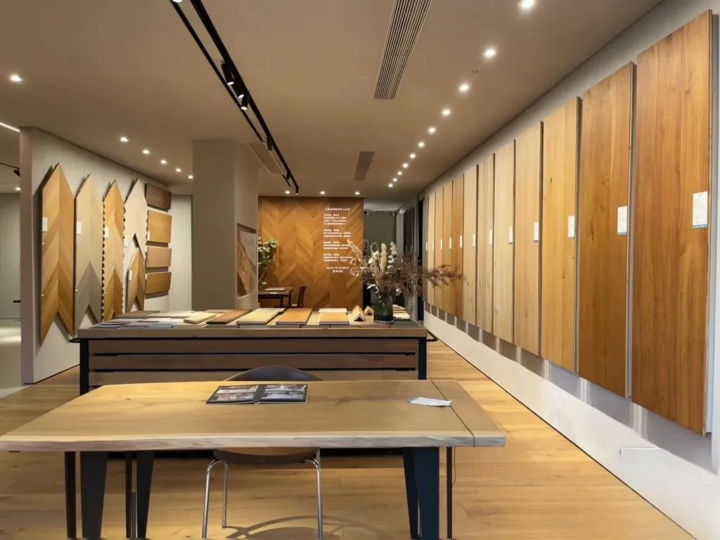 Kingsun China wood tile showroom displaying full-size planks and chevron panels for professional flooring selection.